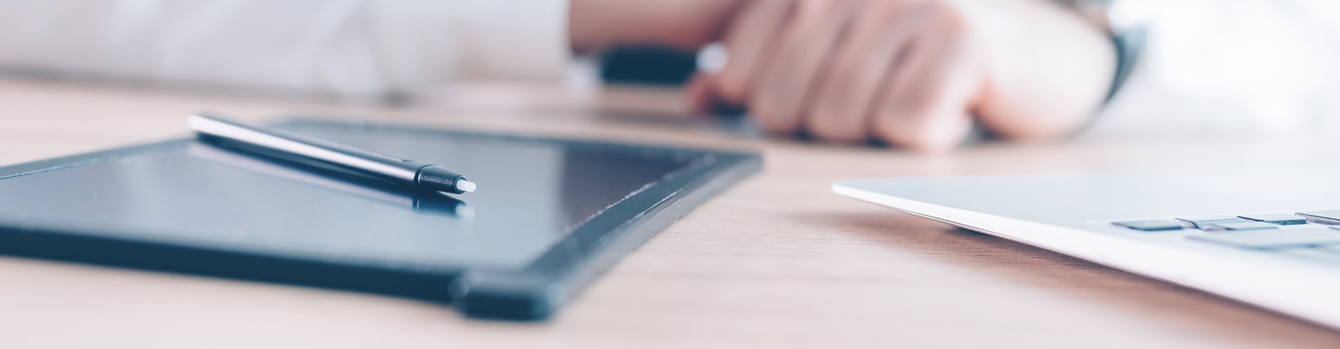 closeup of a tablet on a desk with a stylus