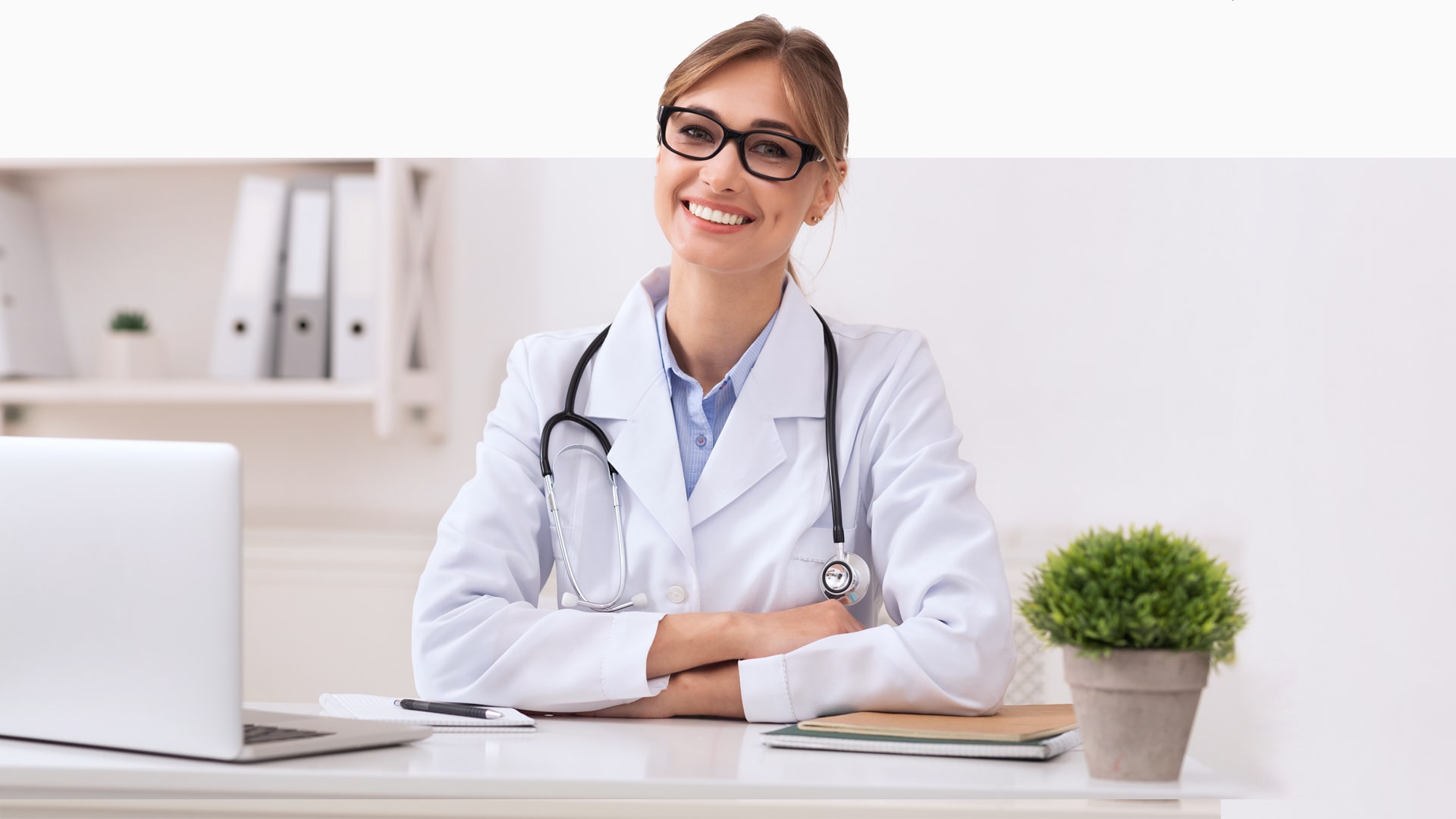 Female doctor sitting at a desk smiling