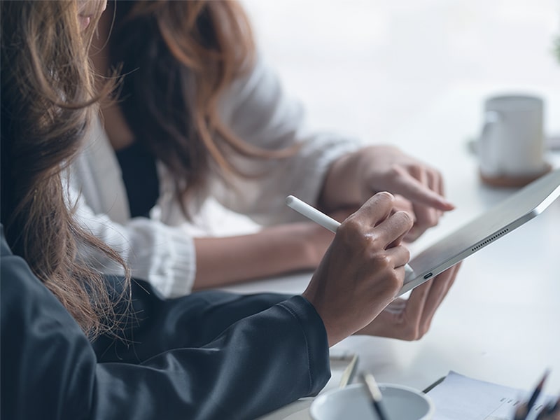 Two women holding a tablet