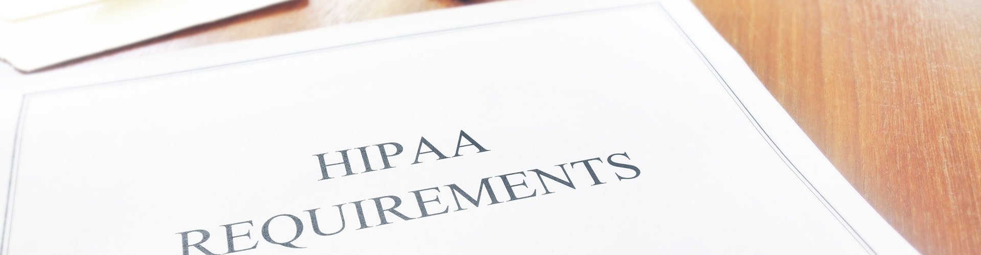 HIPAA Requirements on documents laying on desk