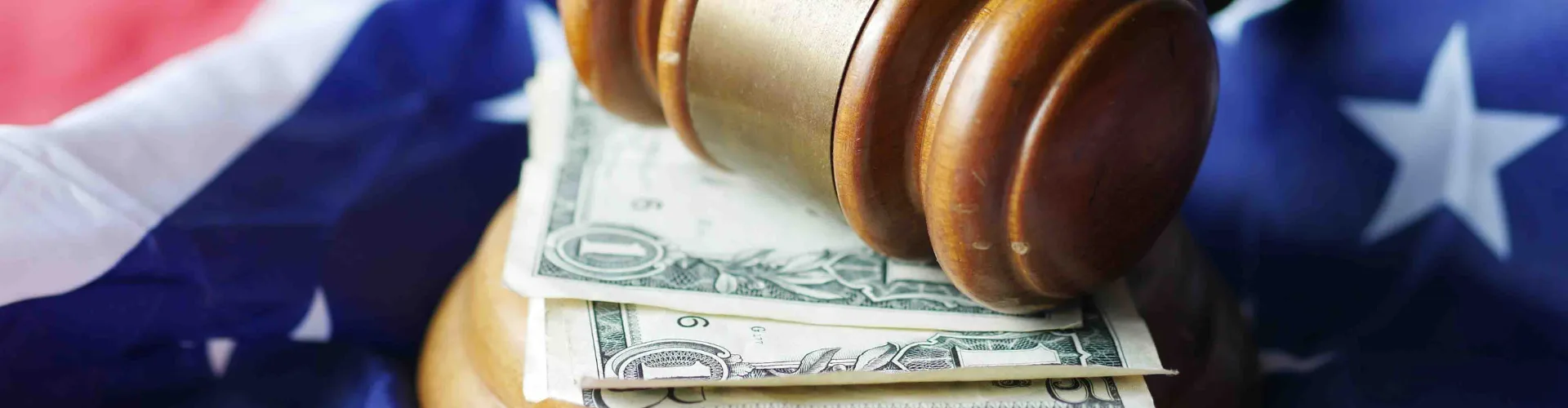 gavel on top of money and American flag