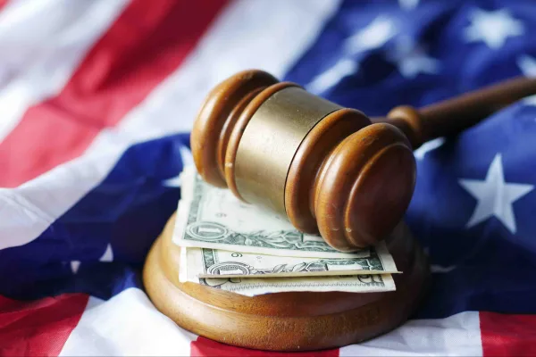 gavel on top of money and American flag