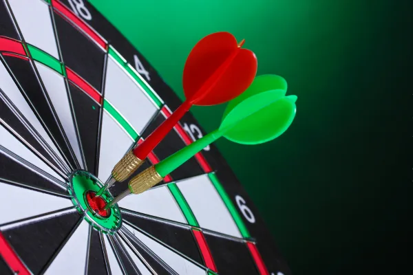 dartboard with green and red darts