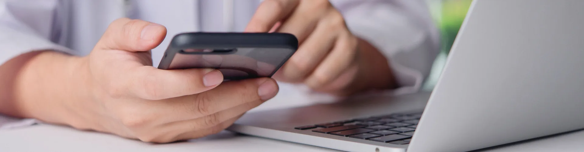doctor with phone and laptop